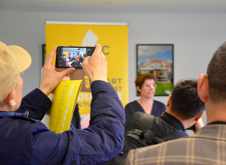 People taking photos at a community consultation